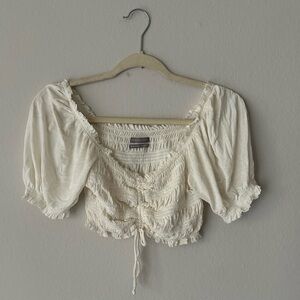 UO Delicate Cinched Puff Sleeve Smocked Cropped Top in Ivory Medium